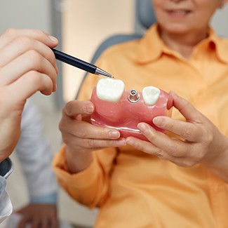 Digital image of dental implant and man’s smile