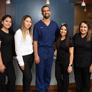 Smiling dental team members and dentist near Casa View Dallas Texas