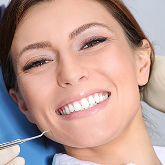 Smiling patient in a dental chair