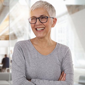 Older woman smiling with dental crowns in Dallas