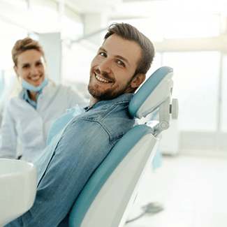 a patient smiling about the cost of dental crowns