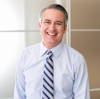 Senior man in business attire smiling