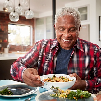 Man eating lunch and smiling