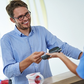 person paying their dental bill