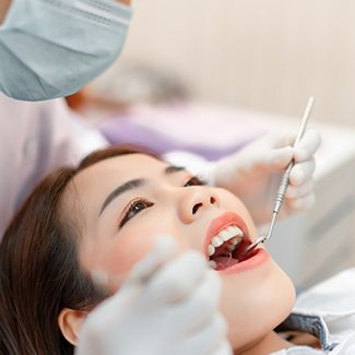 a dentist examining a patient’s mouth