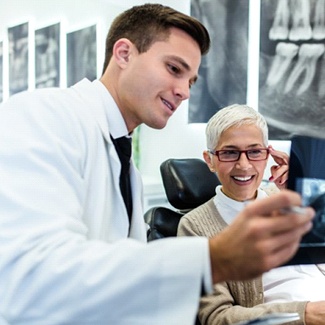 A dentist showing an older patient an X ray