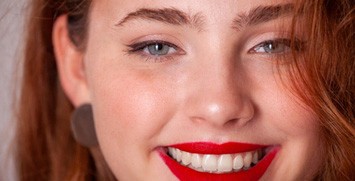 Woman with bright lipstick smiling