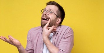 Man pulling lip back to reveal missing tooth