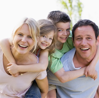 Smiling mother father and two children