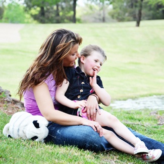 Mother holding her child outdoors