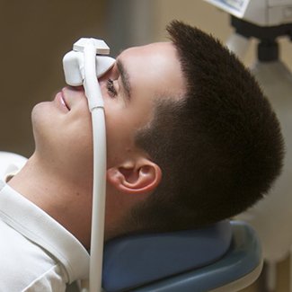 Man wearing nitrous oxide mask over his nose