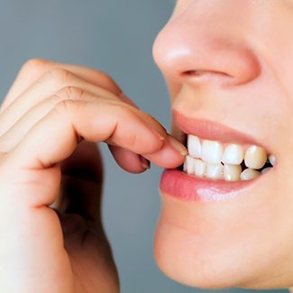 Closeup of patient biting their nails