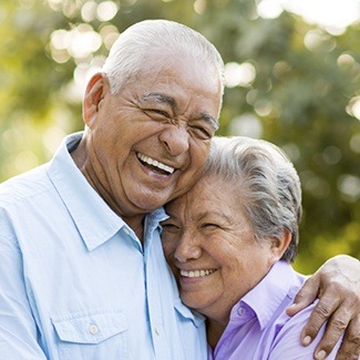 Laughing older man and woman outdoors