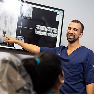 Dr. Tadros explaining dental digital x-rays to a patient