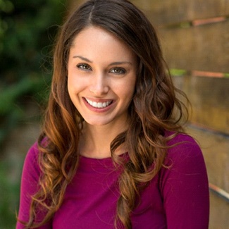 A woman with veneers in Dallas smiling outside