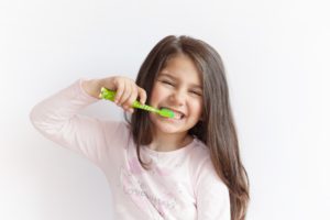 Girl brushing teeth at children’s dentist in East Dallas