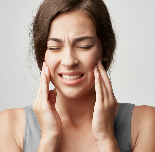 Woman holding face in pain